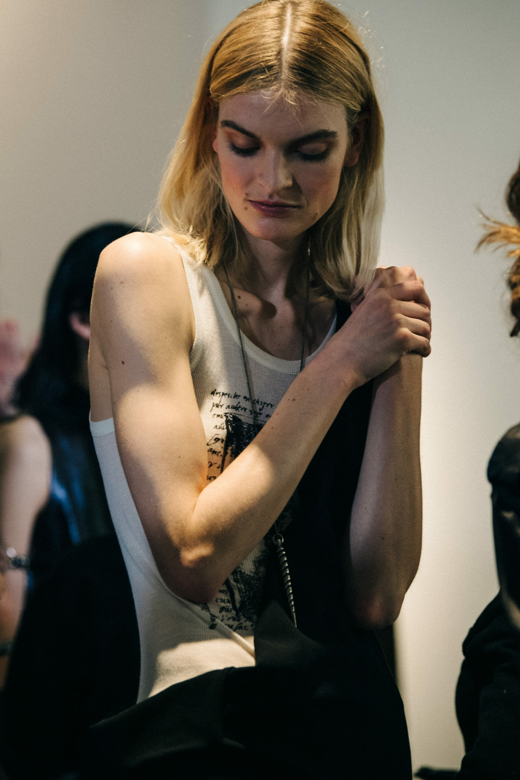 Model wearing white vest at Ann Demeulemeester