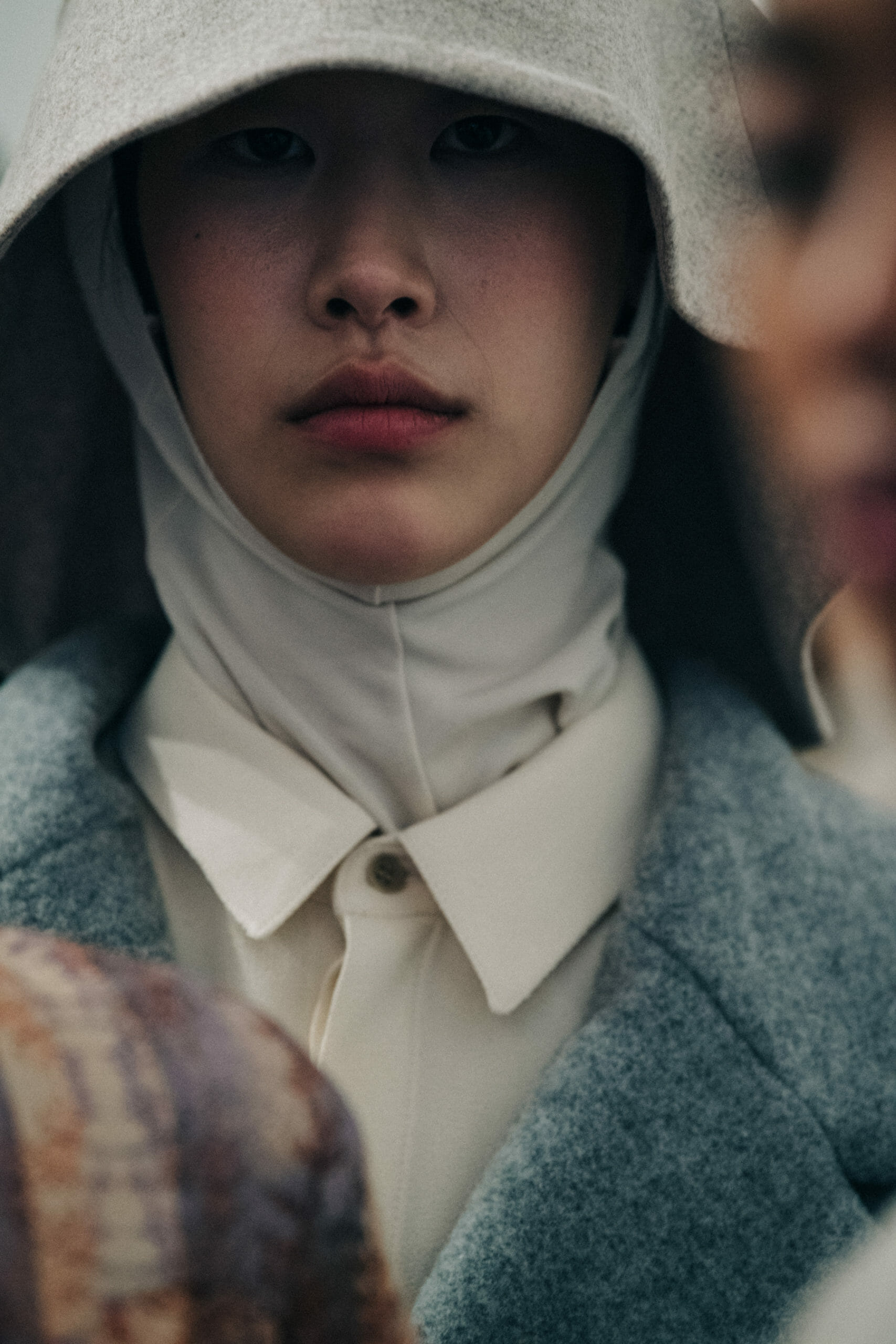 Model wearing long wool coat at Nehera