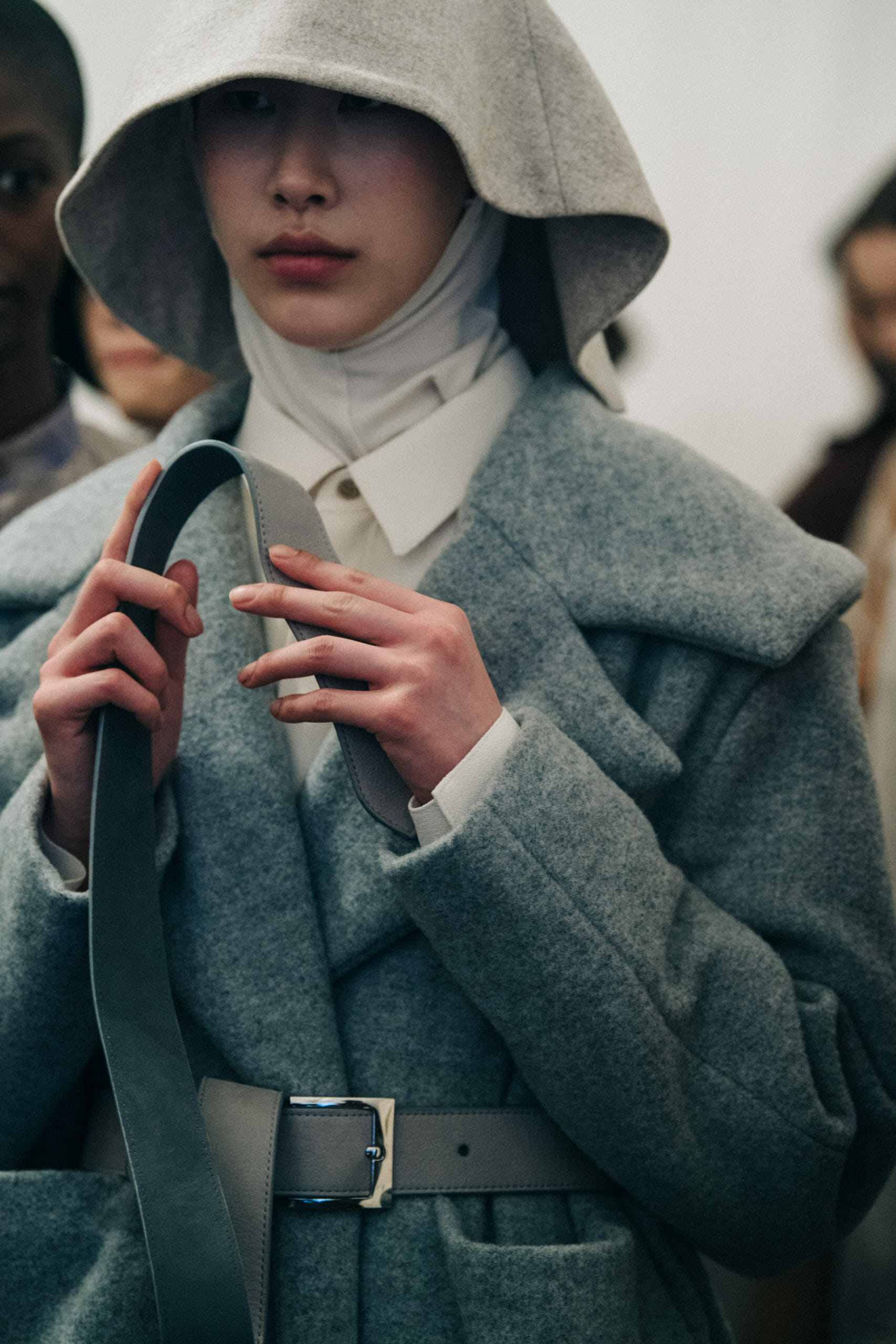 Model wearing long wool coat at Nehera