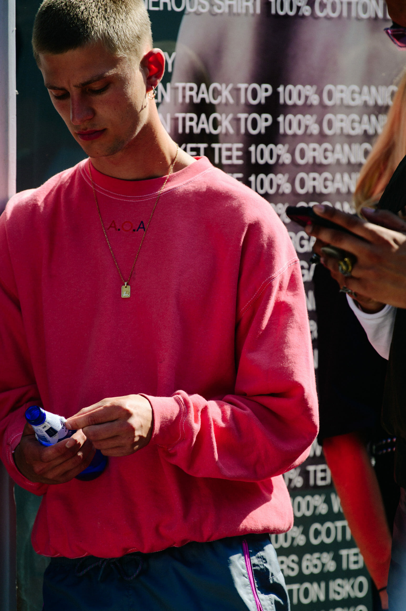 Man wearing pink jumper