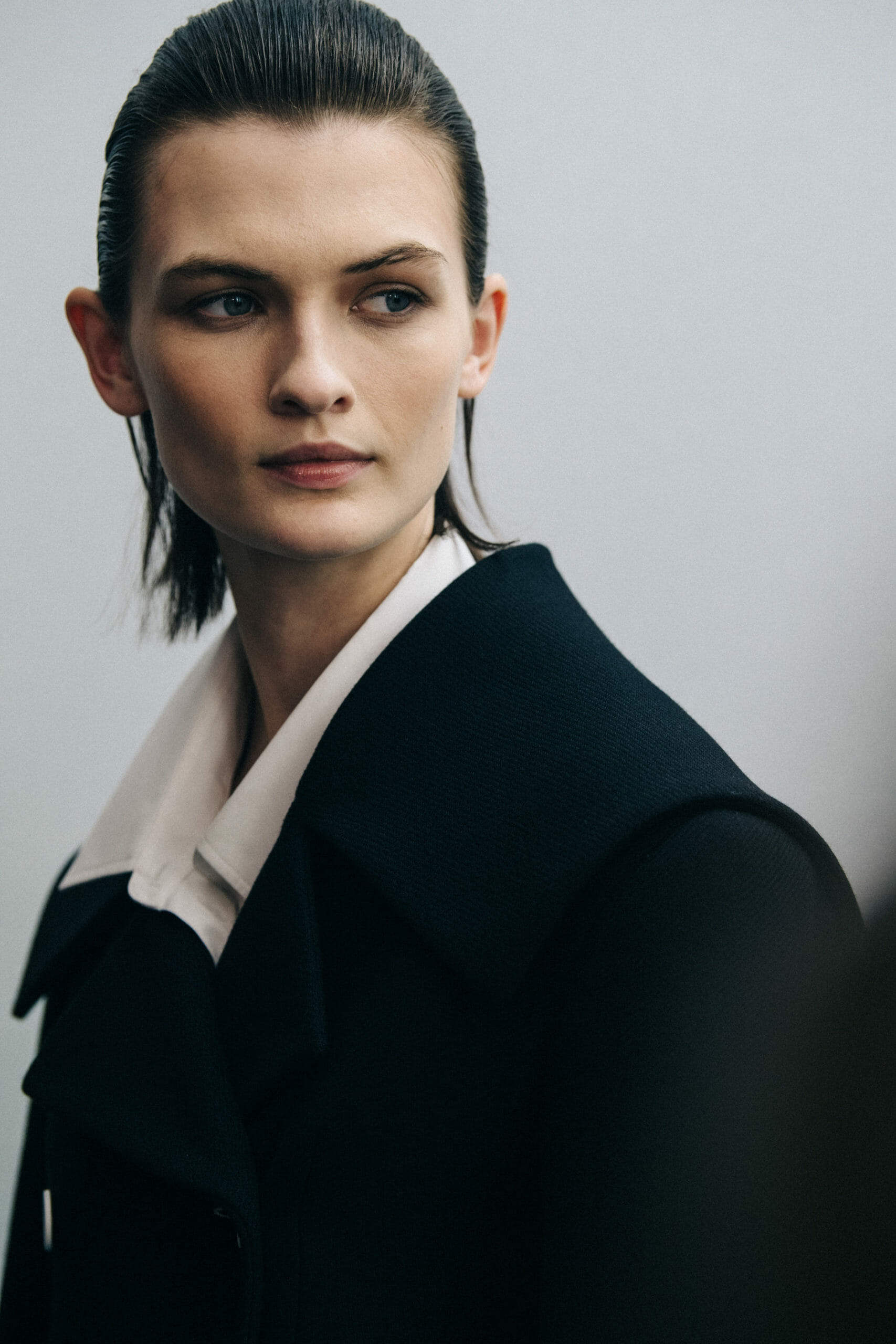 Model wearing dark coat at Nina Ricci