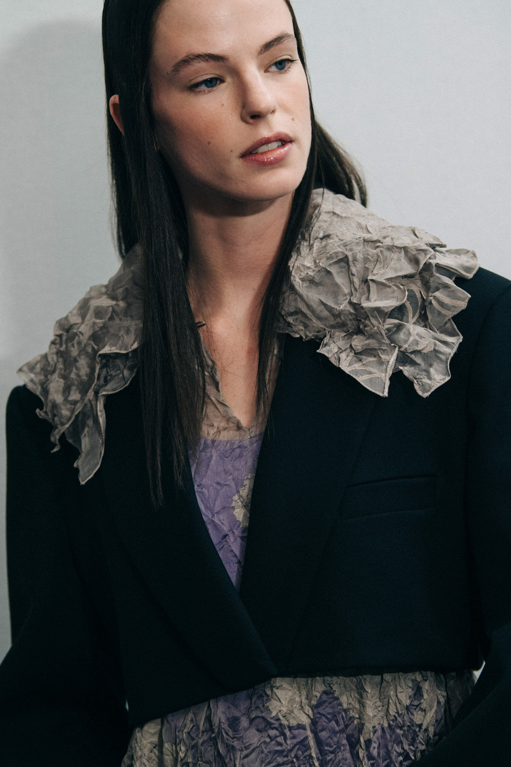 Model wearing dark coat at Nina Ricci