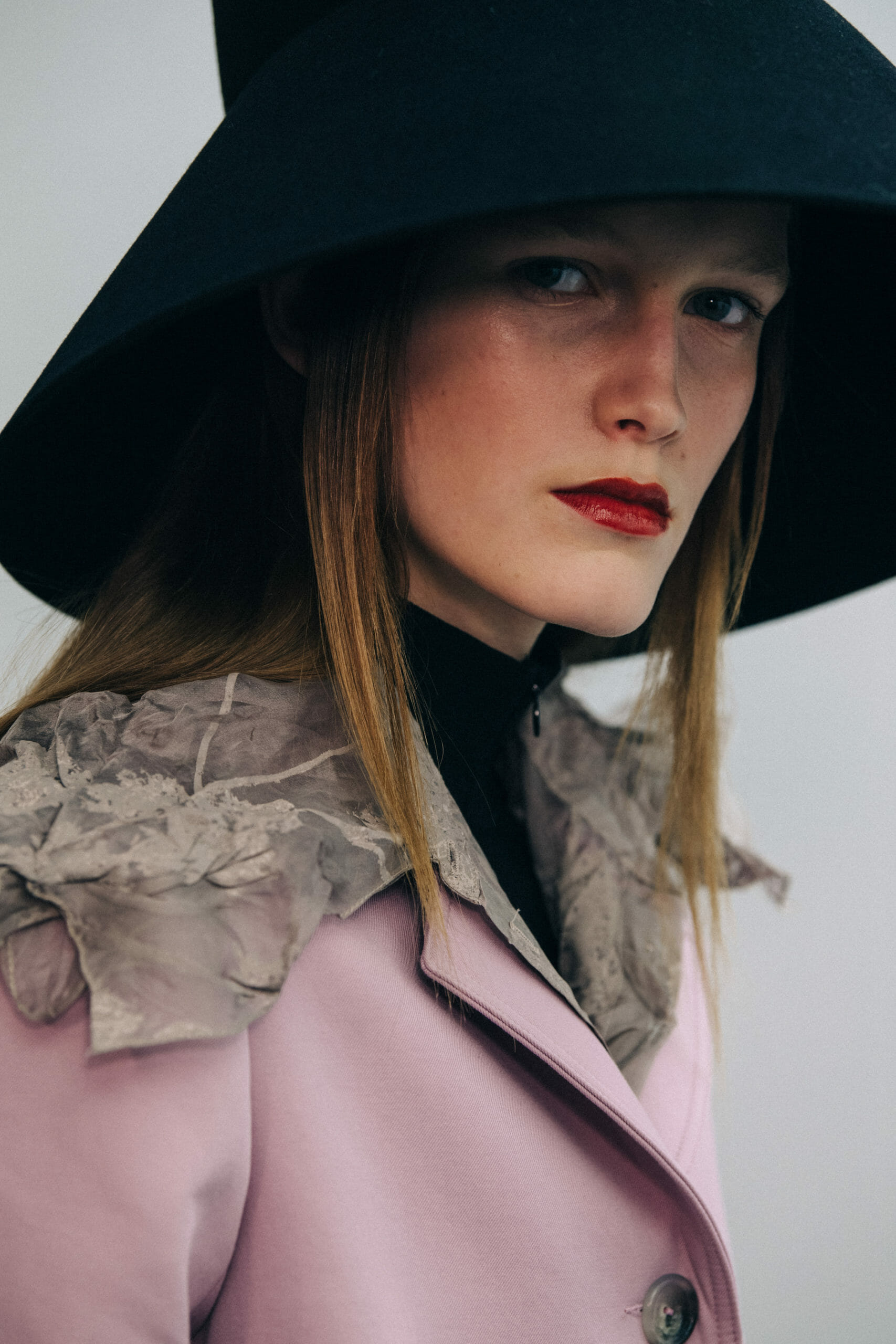 Model wearing large hat at Nina Ricci