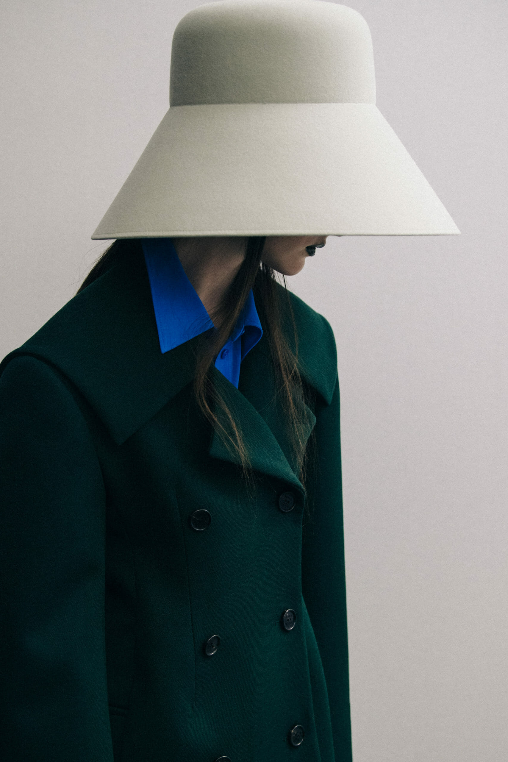 Model wearing large hat at Nina Ricci