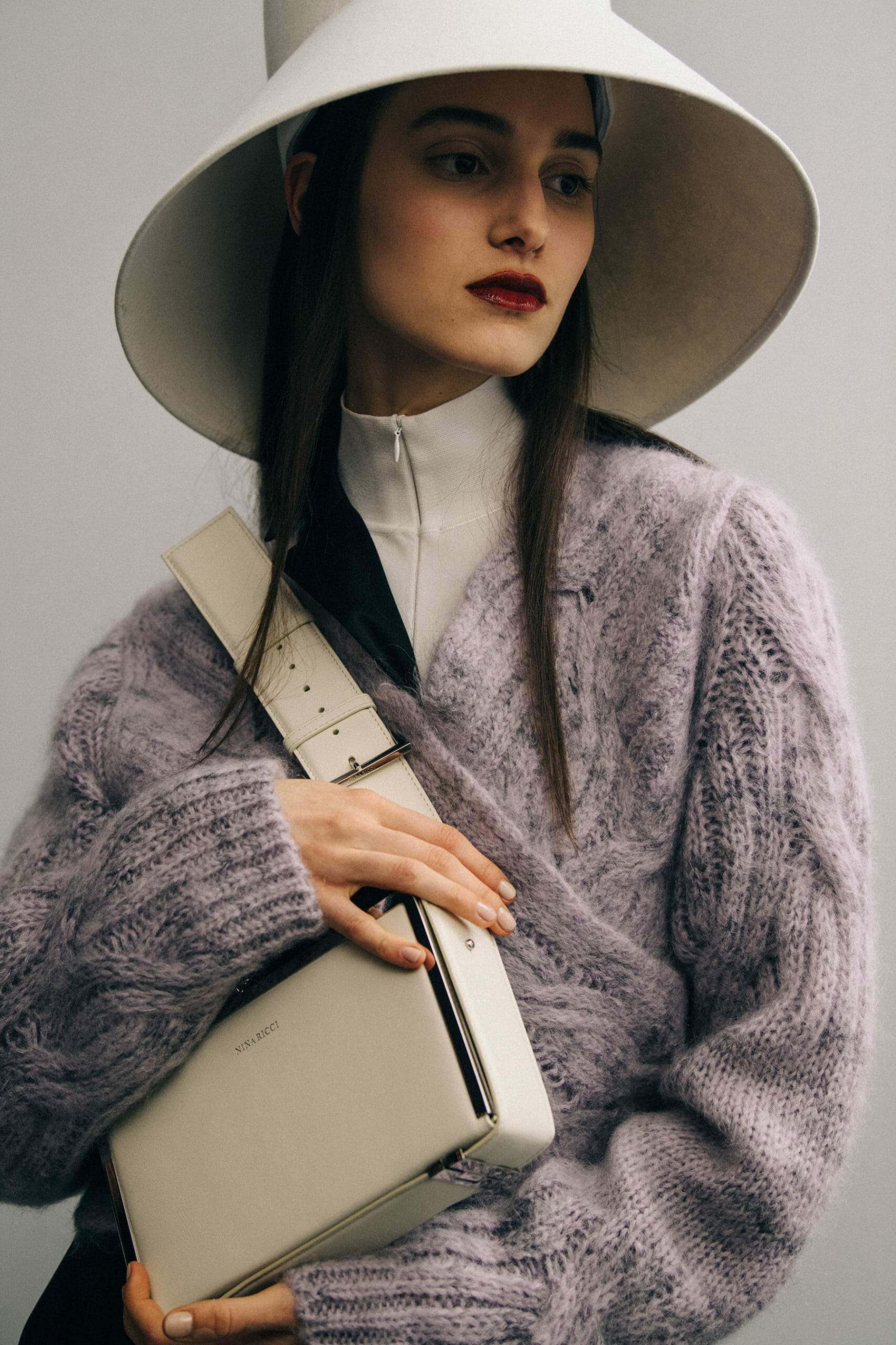 Model wearing large hat at Nina Ricci