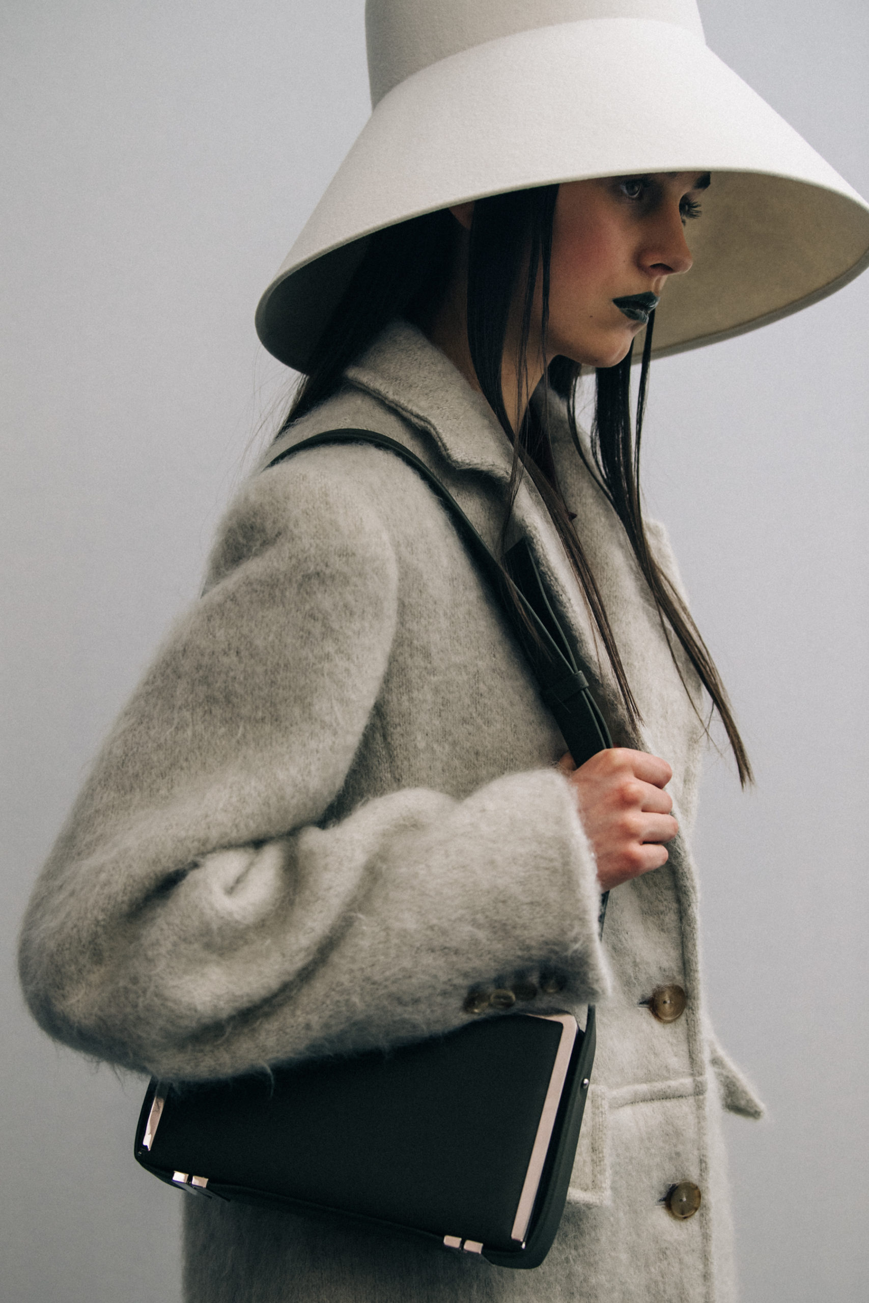 Model wearing large hat at Nina Ricci