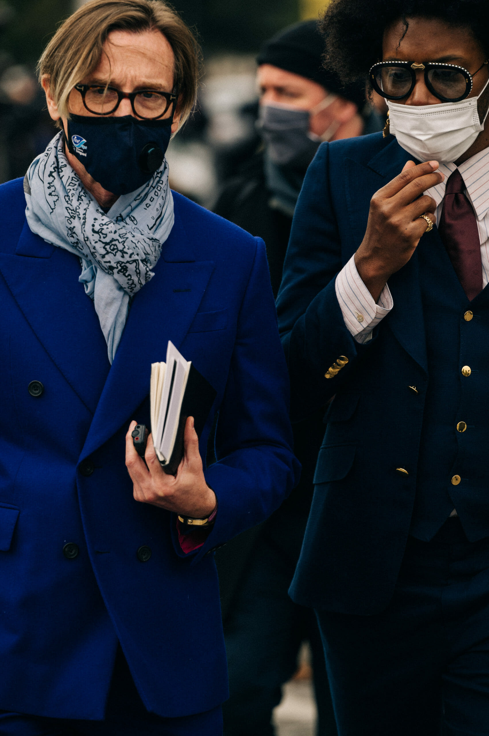 British editor of Vogue America and american actor wearing masks