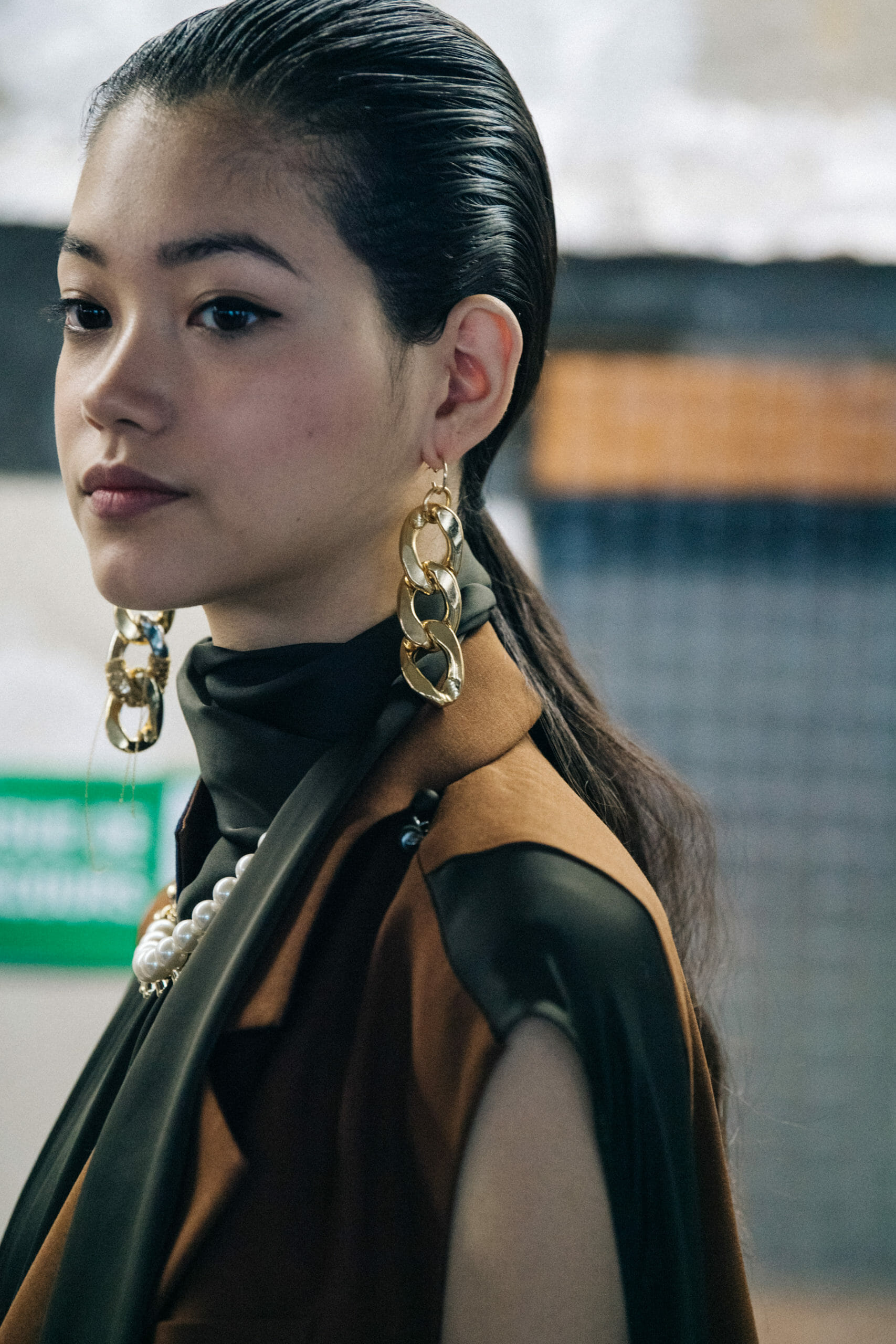 Model wearing brown at Sacai