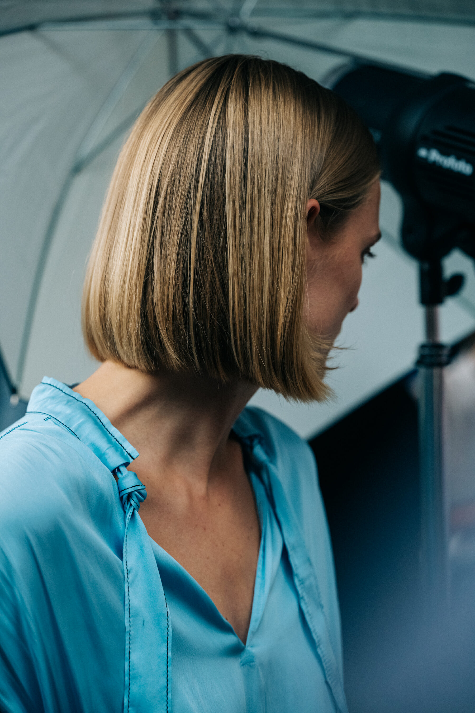 Model backstage wearing blue