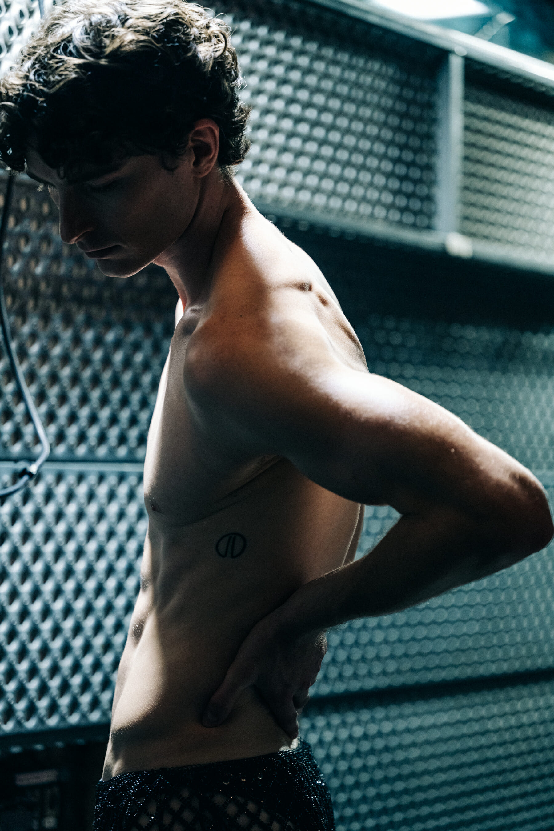 Male model shirtless tattoo detail