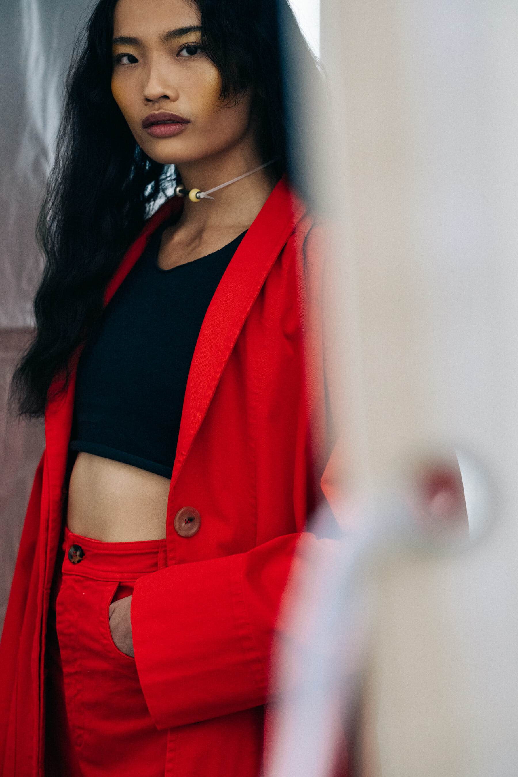 Model backstage wearing red