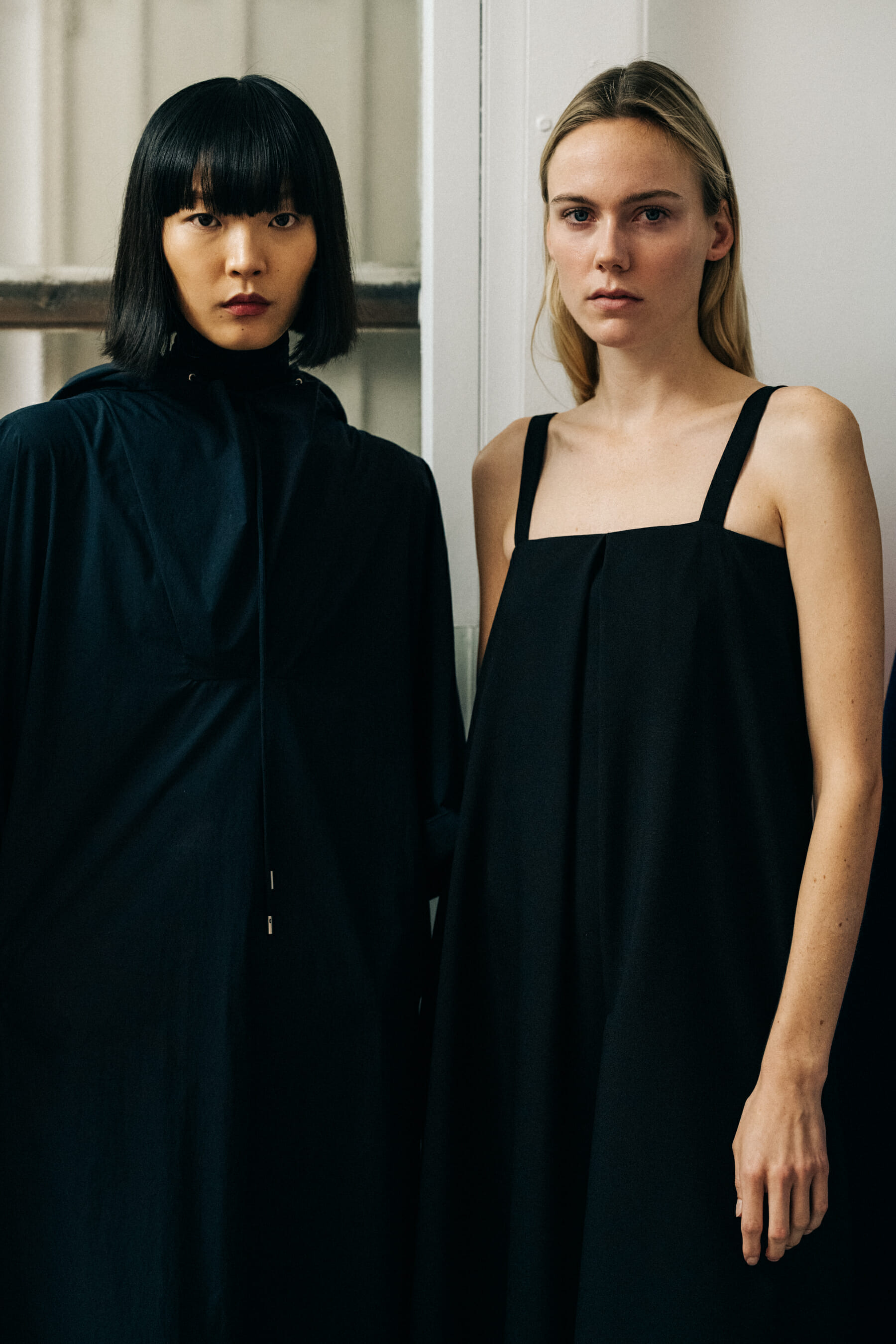 Two models wearing black